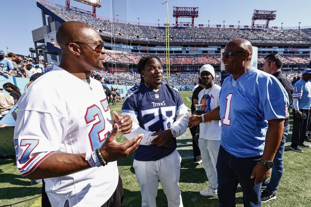 Former Houston Oiler quarterback Warren Moon, right, talks with former Titans running backs Chris Johnson, center, and Eddie George before a game between the Indianapolis Colts and Tennessee Titans Sunday, Oct. 23, 2022, in Nashville, Tenn. (AP Photo/Wade Payne)