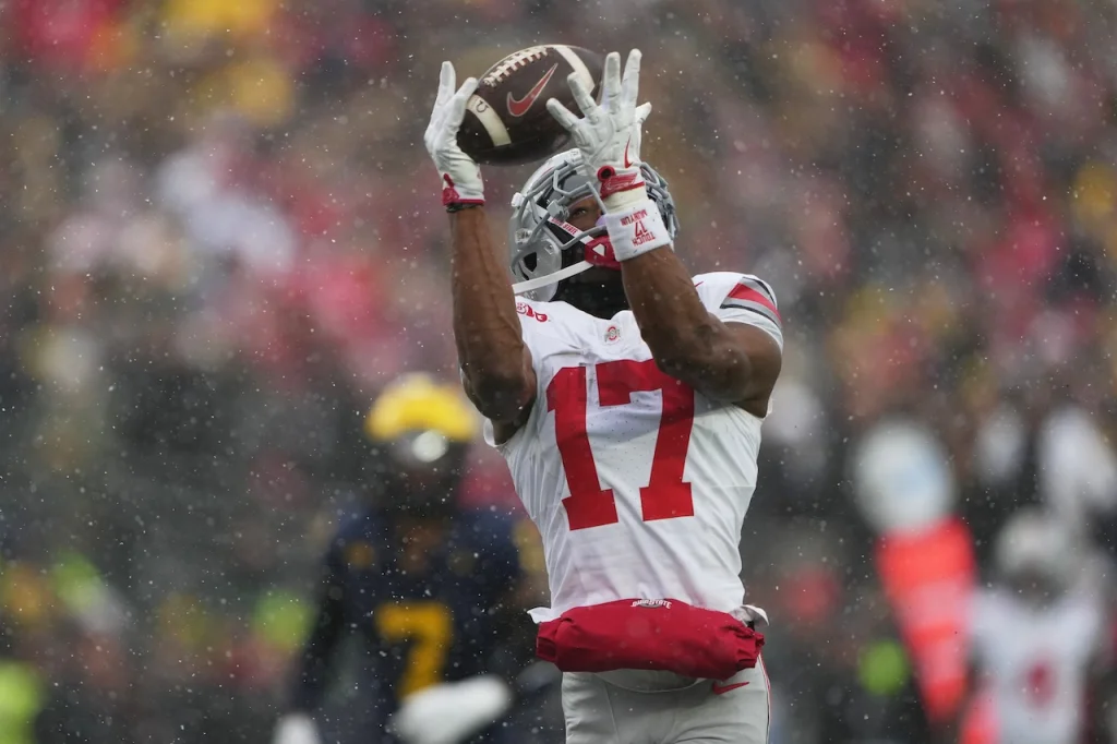 Ohio State Buckeyes wide receiver Carnell Tate catches a pass for a touchdown during the second half of an NCAA college football game against Michigan, Saturday, Nov. 29, 2025, in Ann Arbor, Mich. (AP Photo/Ryan Sun)