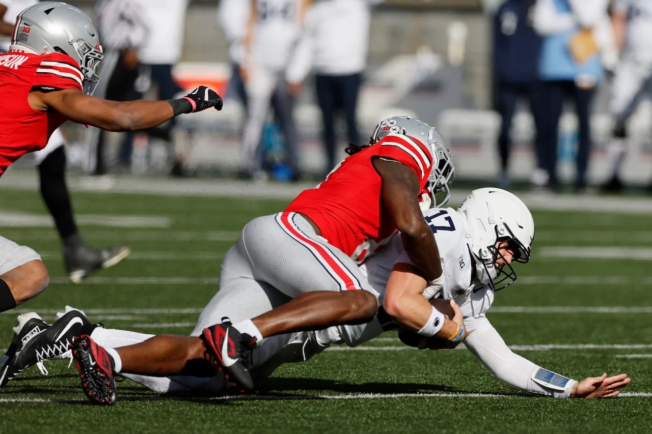 Ohio State linebacker Arvell Reese, top, sacks Penn State quarterback Ethan Grunkemeyer during the second half of an NCAA college football game, Saturday, Nov. 1, 2025, in Columbus, Ohio. (AP Photo/Jay LaPrete)