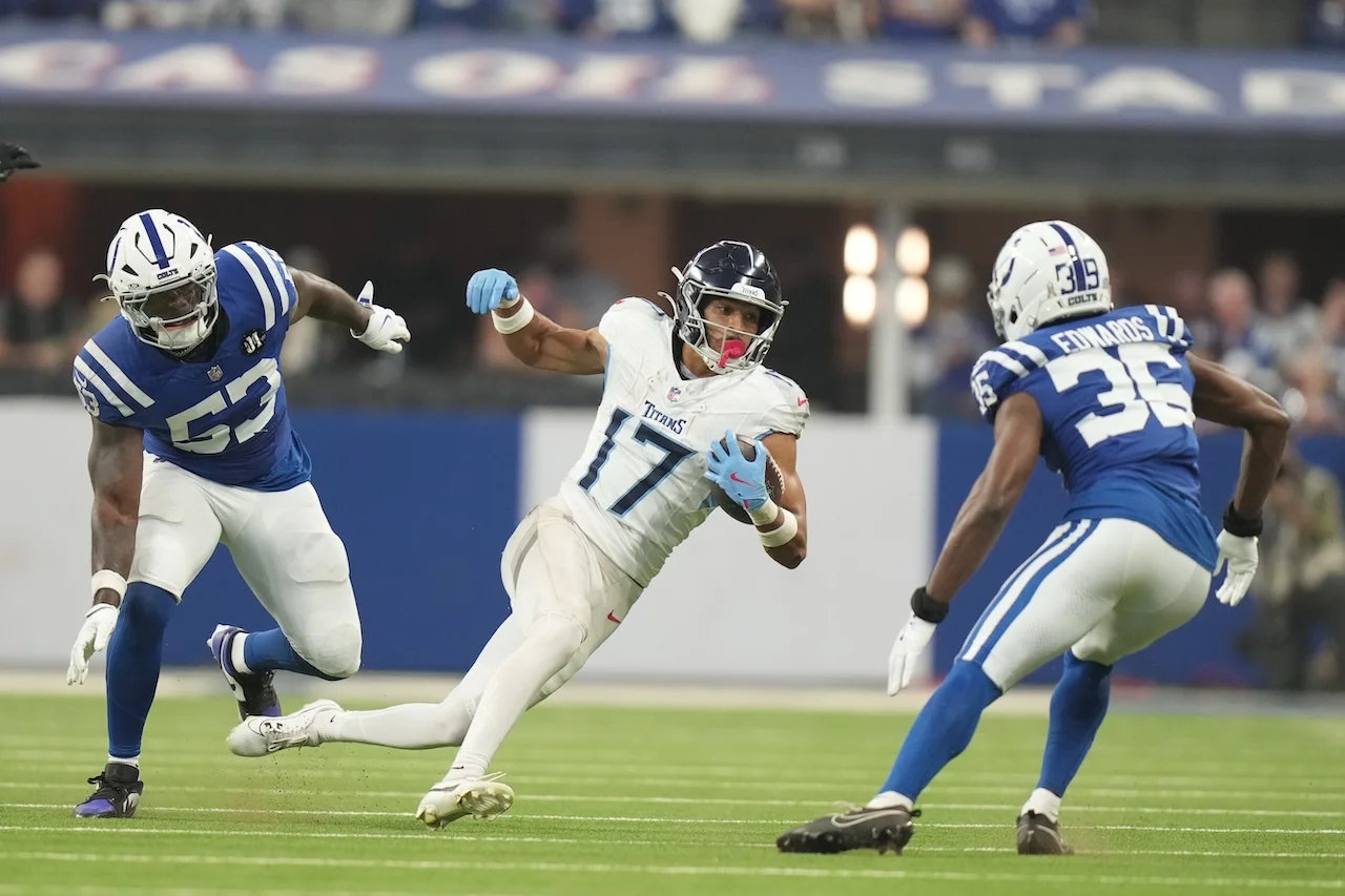 Tennessee Titans wide receiver Chimere Dike (17) runs against Indianapolis Colts safety Reuben Lowery III (36) and linebacker Germaine Pratt (53) during the first half an NFL football game, Sunday, Oct. 26, 2025, in Indianapolis. (AP Photo/AJ Mast)