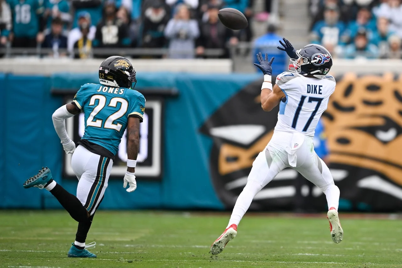 Tennessee Titans wide receiver Chimere Dike (17) makes a catch past Jacksonville Jaguars cornerback Jarrian Jones (22) during the first half of an NFL football game Sunday, Jan. 4, 2026, in Jacksonville, Fla. (AP Photo/Phelan M. Ebenhack)