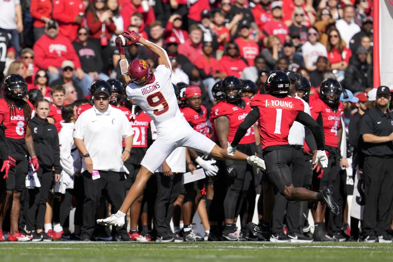 Iowa State wide receiver Jayden Higgins (9) makes a catch against Cincinnati cornerback Jordan Young (1) during the first half of an NCAA college football game, Saturday, Oct. 14, 2023, in Cincinnati. (AP Photo/Jeff Dean)