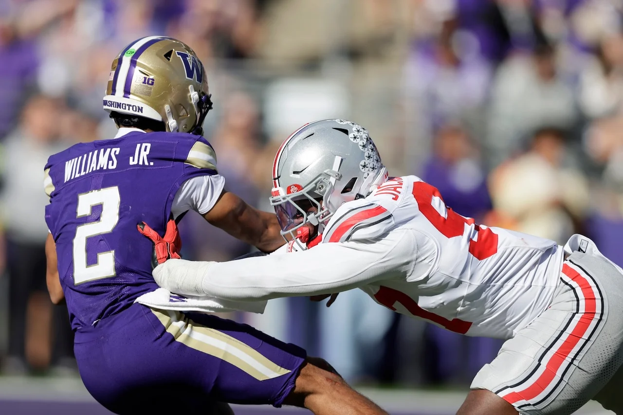 Ohio State defensive end Kenyatta Jackson Jr. (97) hits Washington quarterback Demond Williams Jr. (2) as he throws a pass during the second half of an NCAA college football game, Saturday, Sept. 27, 2025, in Seattle. (AP Photo/John Froschauer)
