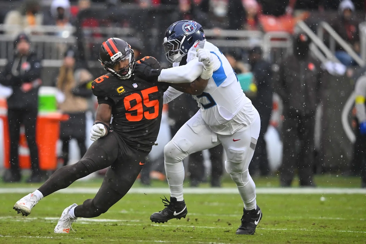 Cleveland Browns defensive end Myles Garrett (95) rushes as Tennessee Titans offensive tackle Dan Moore Jr., right, defends in the first half of an NFL football game in Cleveland, Sunday, Dec. 7, 2025. (AP Photo/David Richard)