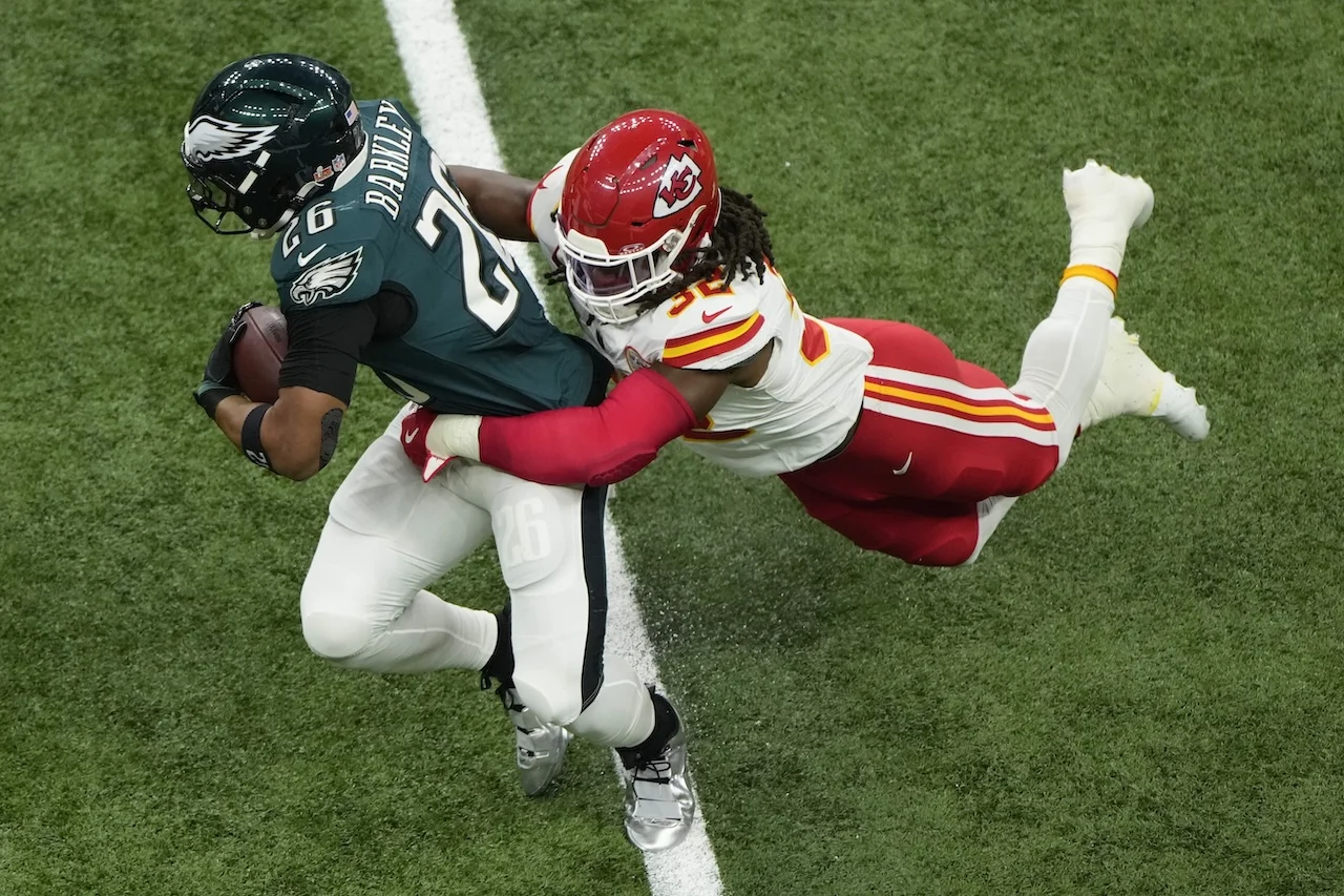 Philadelphia Eagles running back Saquon Barkley (26) is tackled by Kansas City Chiefs linebacker Nick Bolton (32) during the first half of the NFL Super Bowl 59 football game, Sunday, Feb. 9, 2025, in New Orleans. (AP Photo/Charlie Riedel)