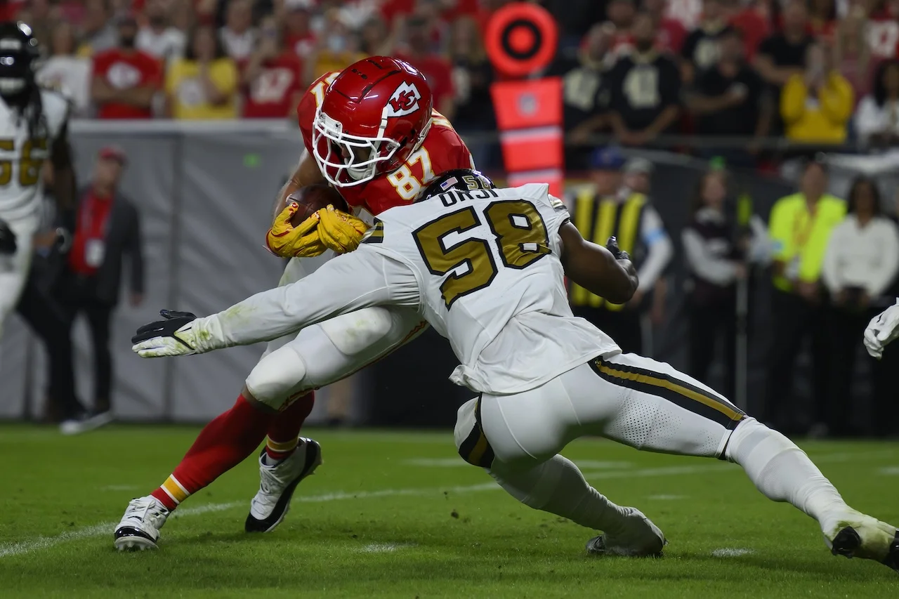 Kansas City Chiefs tight end Travis Kelce (87) is tackled by New Orleans Saints linebacker Anfernee Orji (58) during the first half of an NFL football game, Monday, Oct. 7, 2024 in Kansas City, Mo. The Chiefs defeated the Saints, 26-13. (AP Photo/Reed Hoffmann)