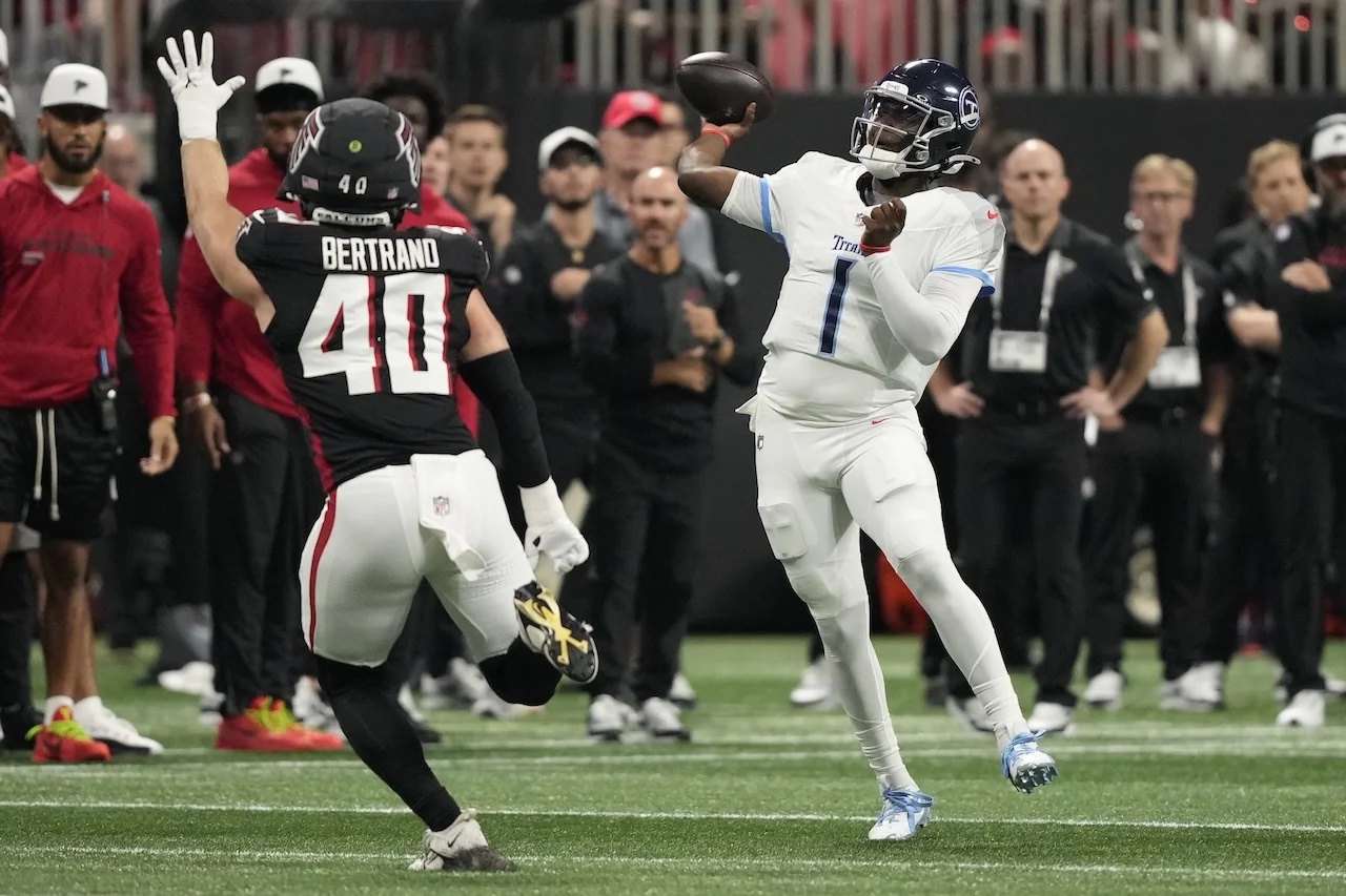 Tennessee Titans quarterback Cameron Ward (1) throws a pass over Atlanta Falcons linebacker JD Bertrand (40) during the first half of a preseason NFL football game, Friday, Aug. 15, 2025, in Atlanta. (AP Photo/Brynn Anderson)