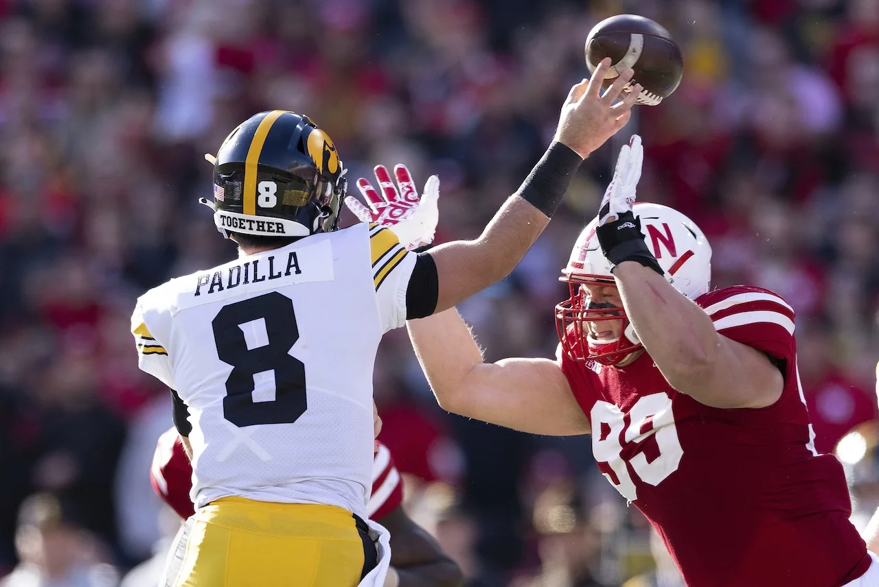 Nebraska's Ty Robinson (99) pressures Iowa quarterback Alex Padilla (8) during the first half of an NCAA college football game Friday, Nov. 26, 2021, at Memorial Stadium in Lincoln, Neb. Robinson was called for a personal foul for roughing the passer on the play. (AP Photo/Rebecca S. Gratz)