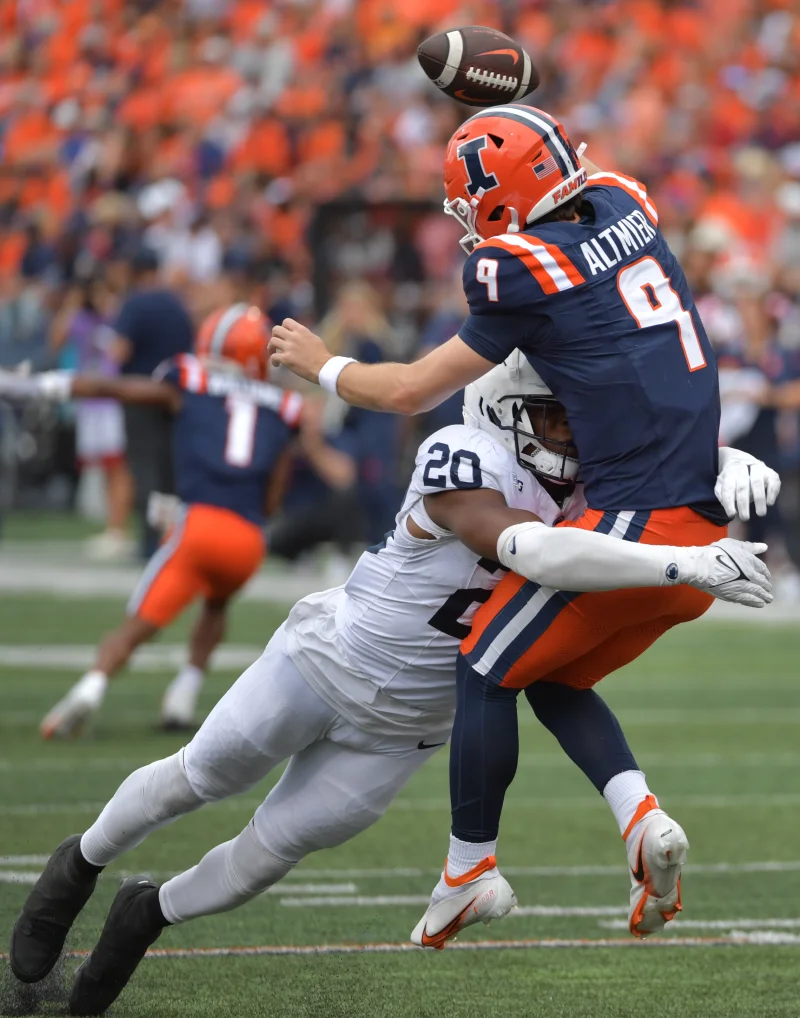 Sep 16, 2023; Champaign, Illinois, USA; Penn State Nittany Lions defensive end Adisa Isaac (20) tackles Illinois Fighting Illini quarterback Luke Altmyer (9) as he passes the ball during the second half at Memorial Stadium. Mandatory Credit: Ron Johnson-USA TODAY Sports