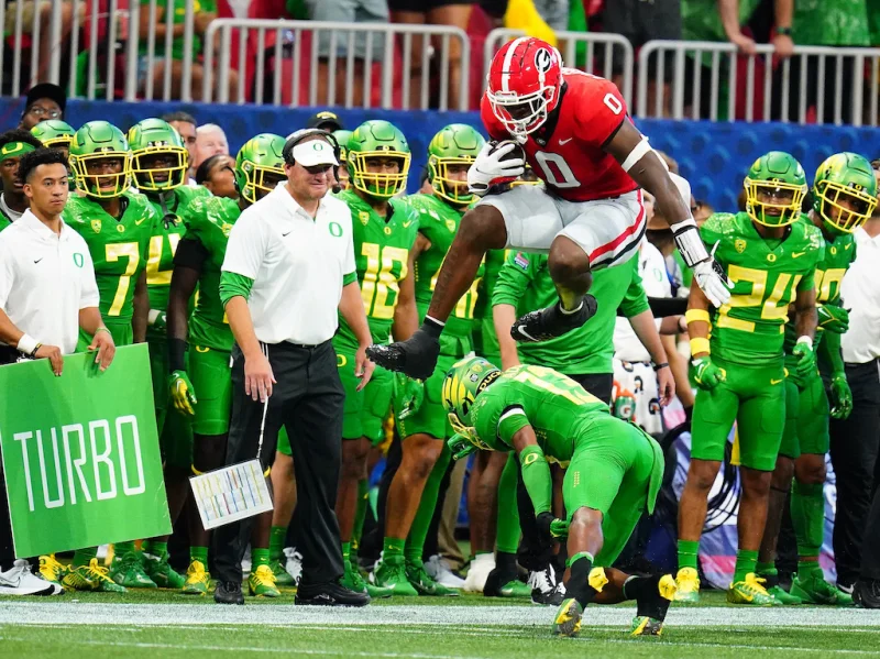 Sep 3, 2022; Atlanta, Georgia, USA; Georgia Bulldogs tight end Darnell Washington (0) hurdles Oregon Ducks defensive back Bryan Addison (13) during the first quarter of the Chick-fil-A kickoff game at Mercedes-Benz Stadium. Mandatory Credit: John David Mercer-USA TODAY Sports