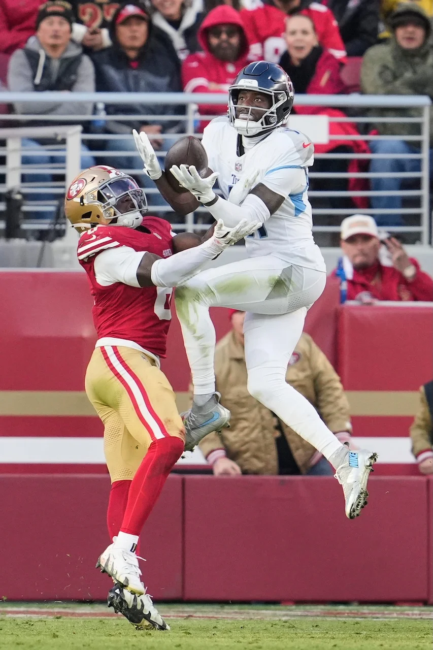 Tennessee Titans wide receiver Van Jefferson, right, makes a catch over San Francisco 49ers safety Malik Mustapha, left, during the second half of an NFL football game, Sunday, Dec. 14, 2025, in Santa Clara, Calif. (AP Photo/Godofredo A. Vásquez)