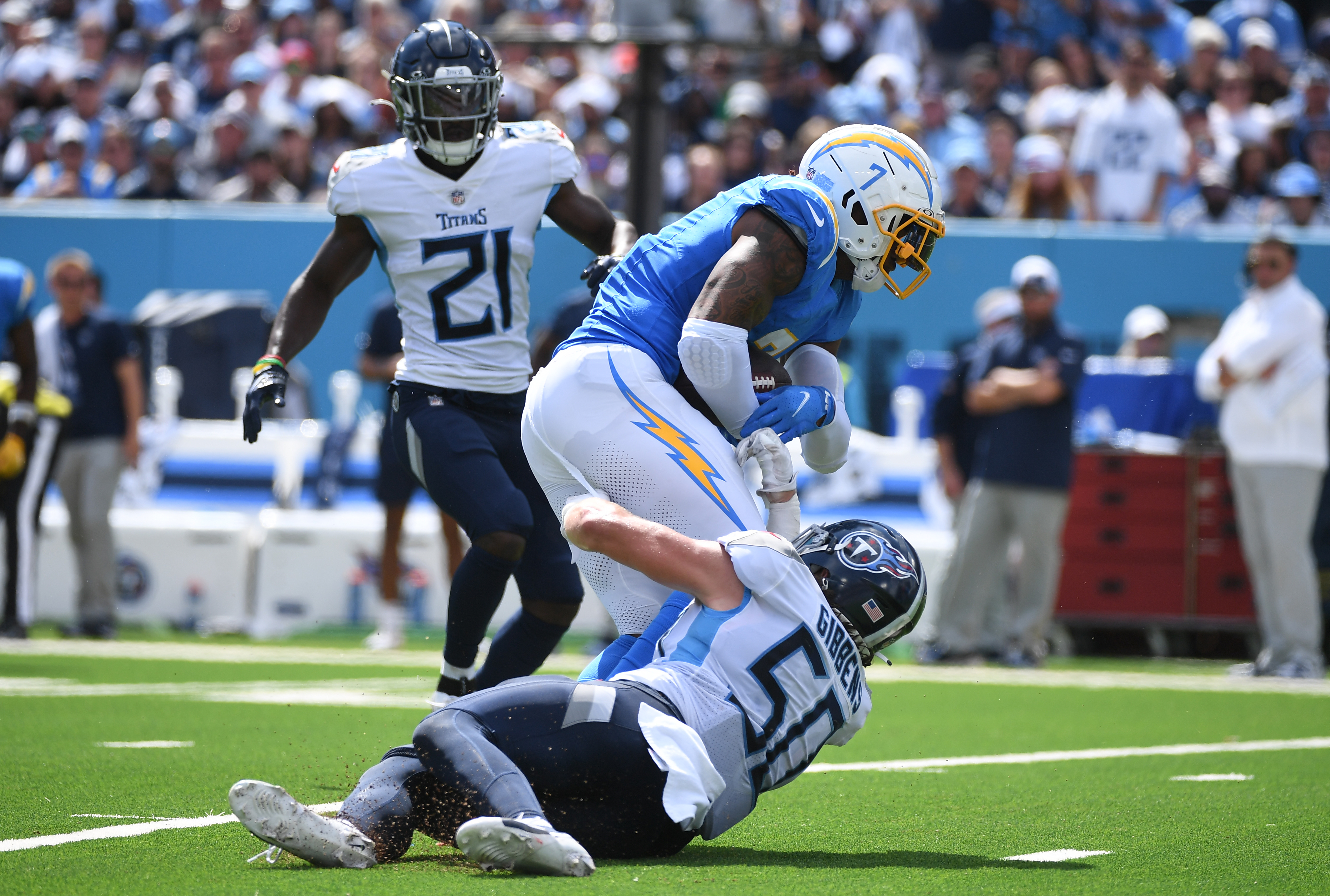 Sep 17, 2023; Nashville, Tennessee, USA; Los Angeles Chargers tight end Gerald Everett (7) runs over a tackle attempt by Tennessee Titans linebacker Jack Gibbens (50) during the second half at Nissan Stadium. Mandatory Credit: Christopher Hanewinckel-USA TODAY Sports