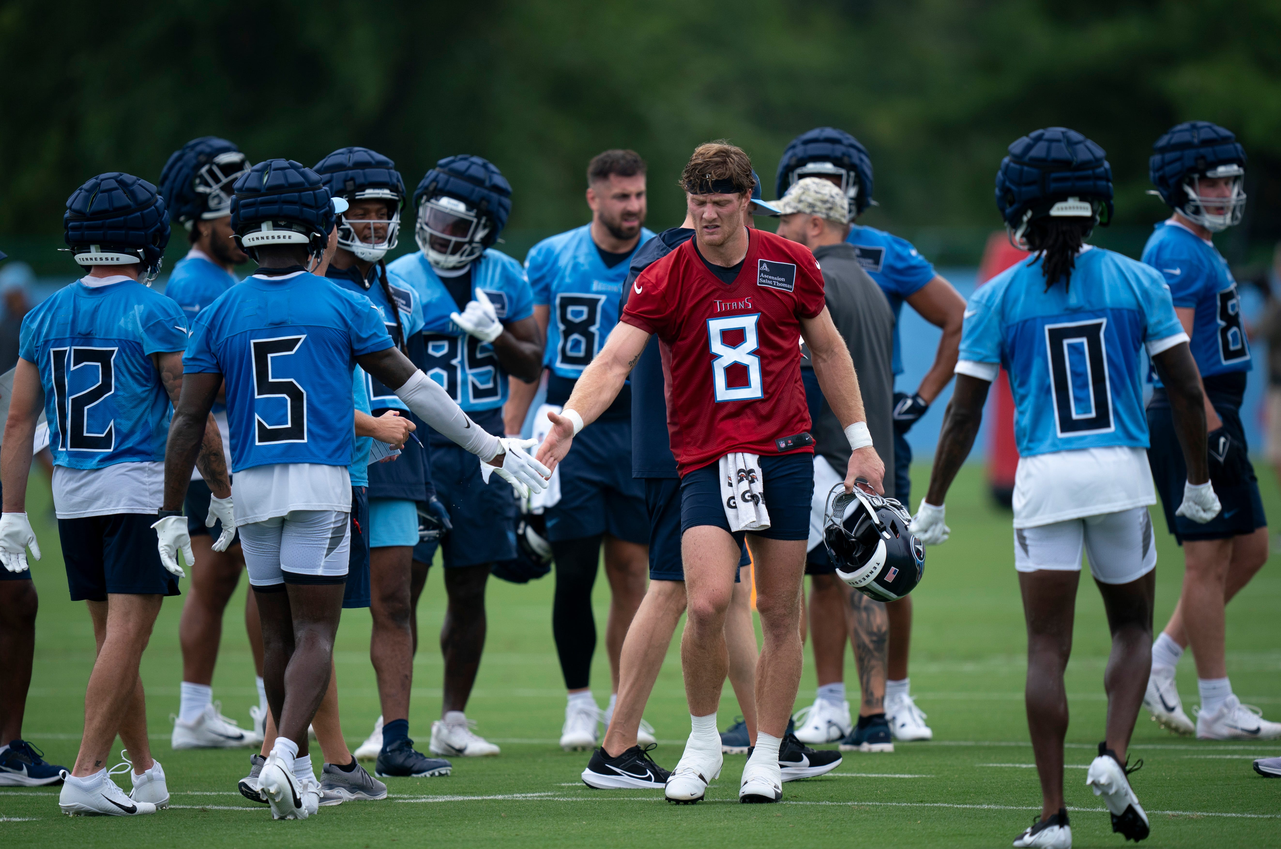 Tennessee Titans quarterback Will Levis (8) congratulates his teammates after running a set of drills on the first day of training camp at Ascension Saint Thomas Sports Park Wednesday, July 24, 2024.