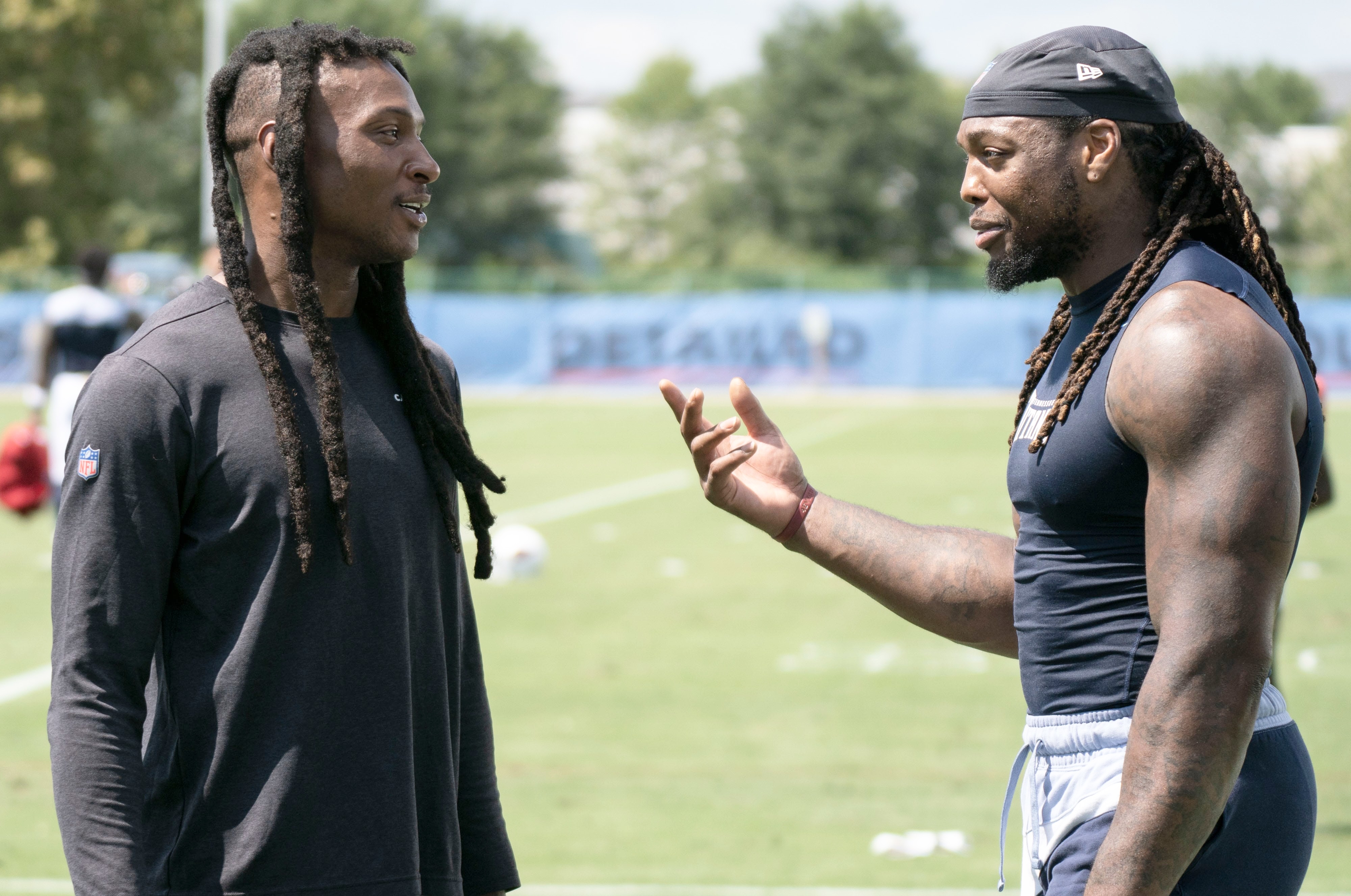 Arizona Cardinals wide receiver DeAndre Hopkins talks with Tennessee Titans running back Derrick Henry after a joint training camp practice at Ascension Saint Thomas Sports Park Wednesday, Aug. 24, 2022, in Nashville, Tenn.